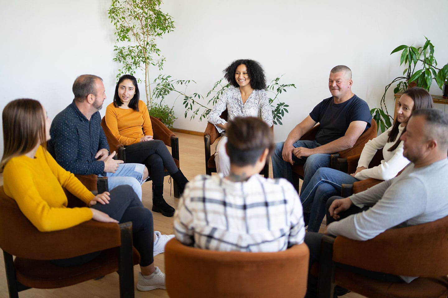 Group of people seated in circle while talking